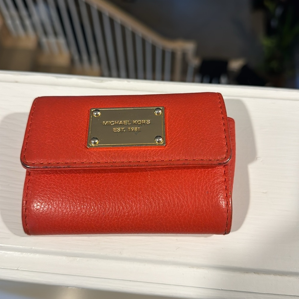 Michael Kors key wallet in orange leather with gold name plate
